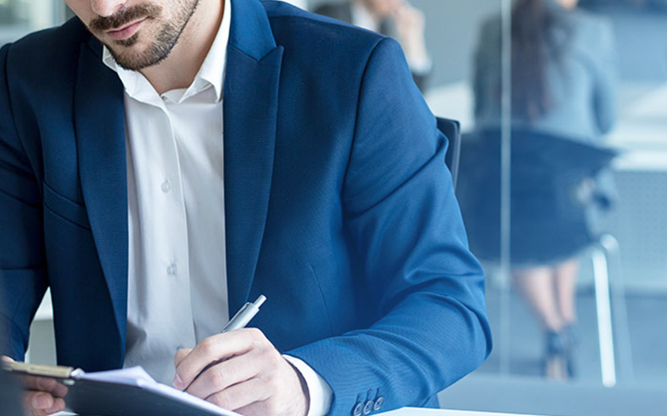 Image of a business man filling out a form or application, part of how Mier Human Capital can help employers